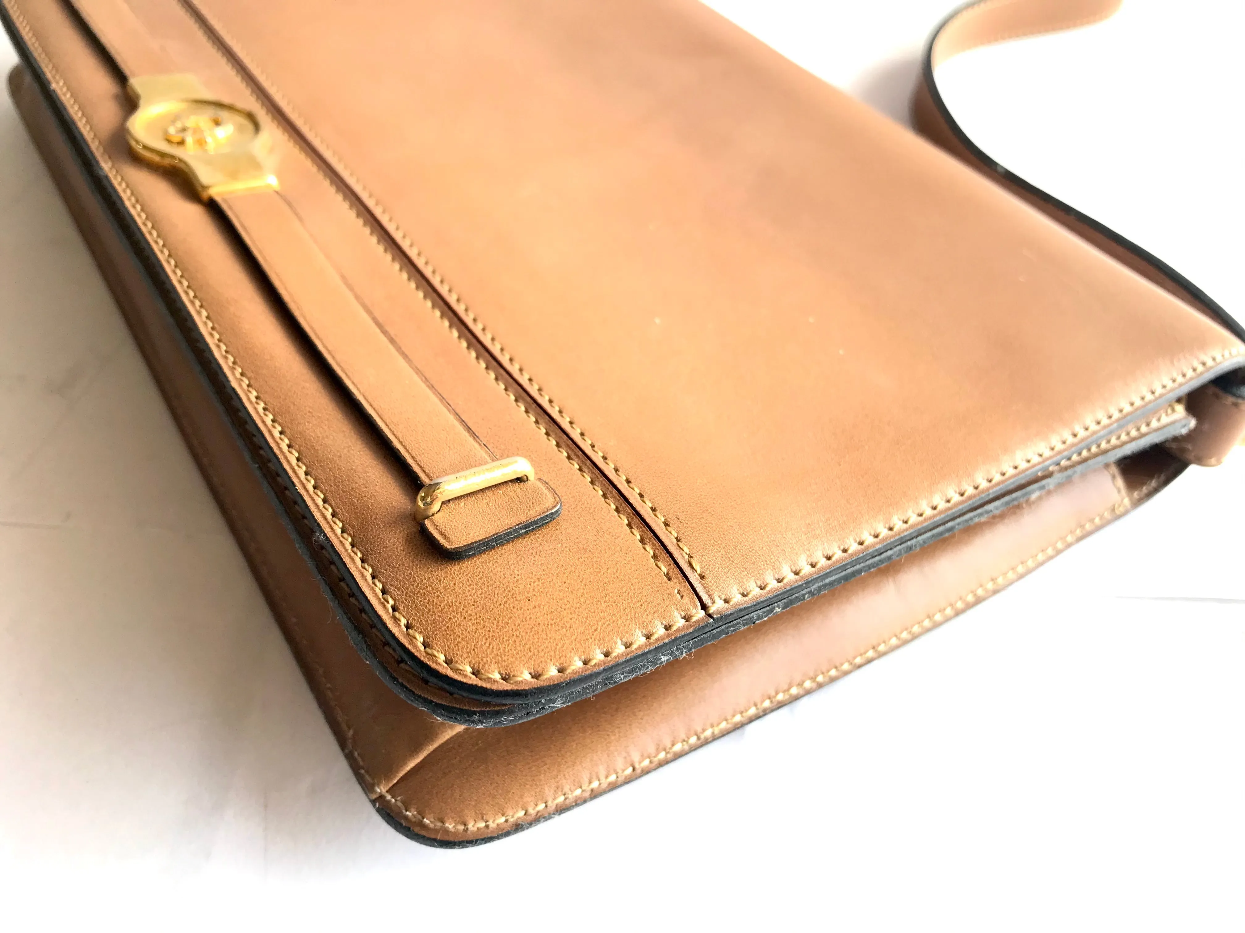 Vintage Christian Dior tanned brown leather shoulder clutch bag with golden CD motif.
