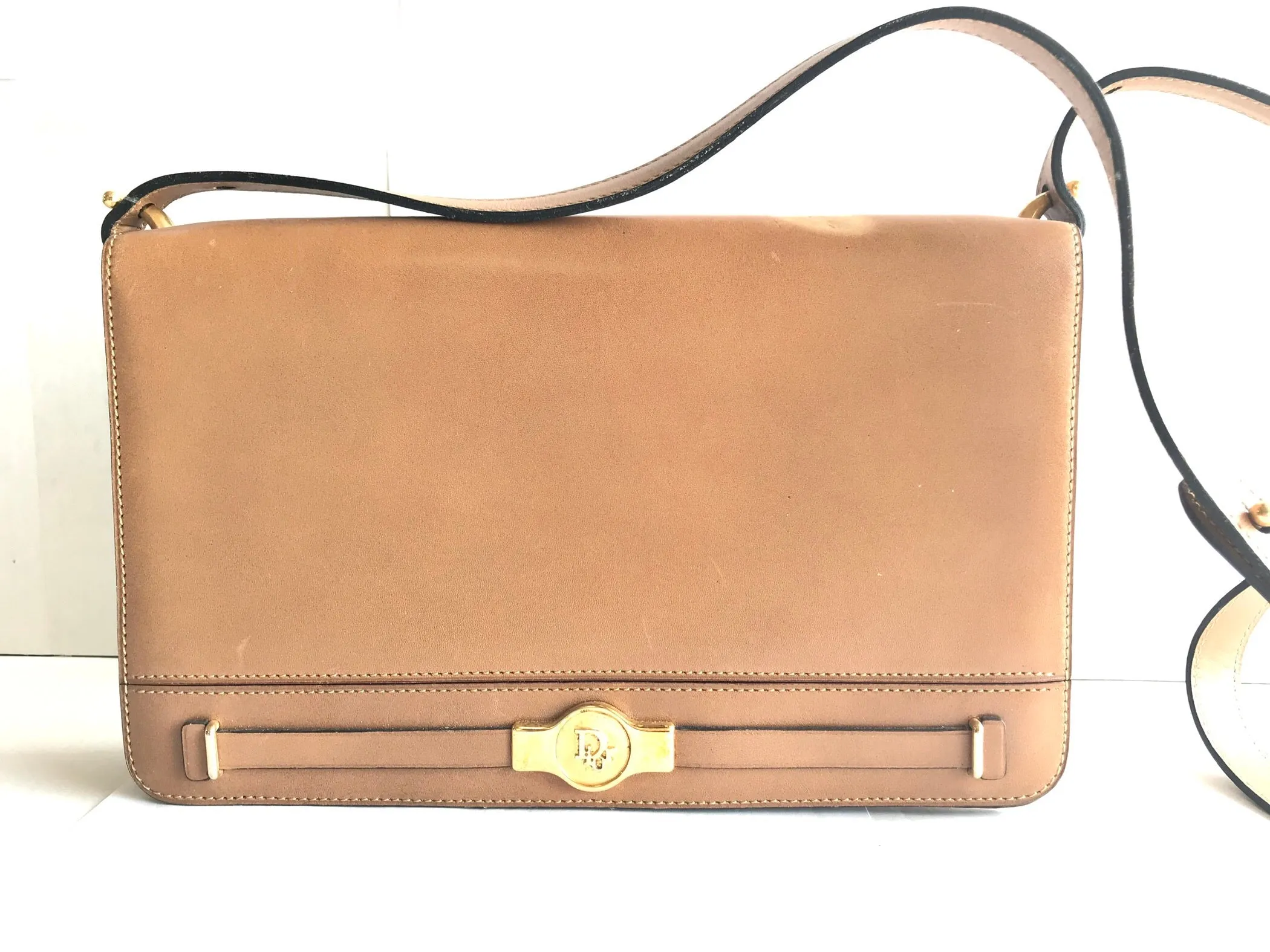 Vintage Christian Dior tanned brown leather shoulder clutch bag with golden CD motif.
