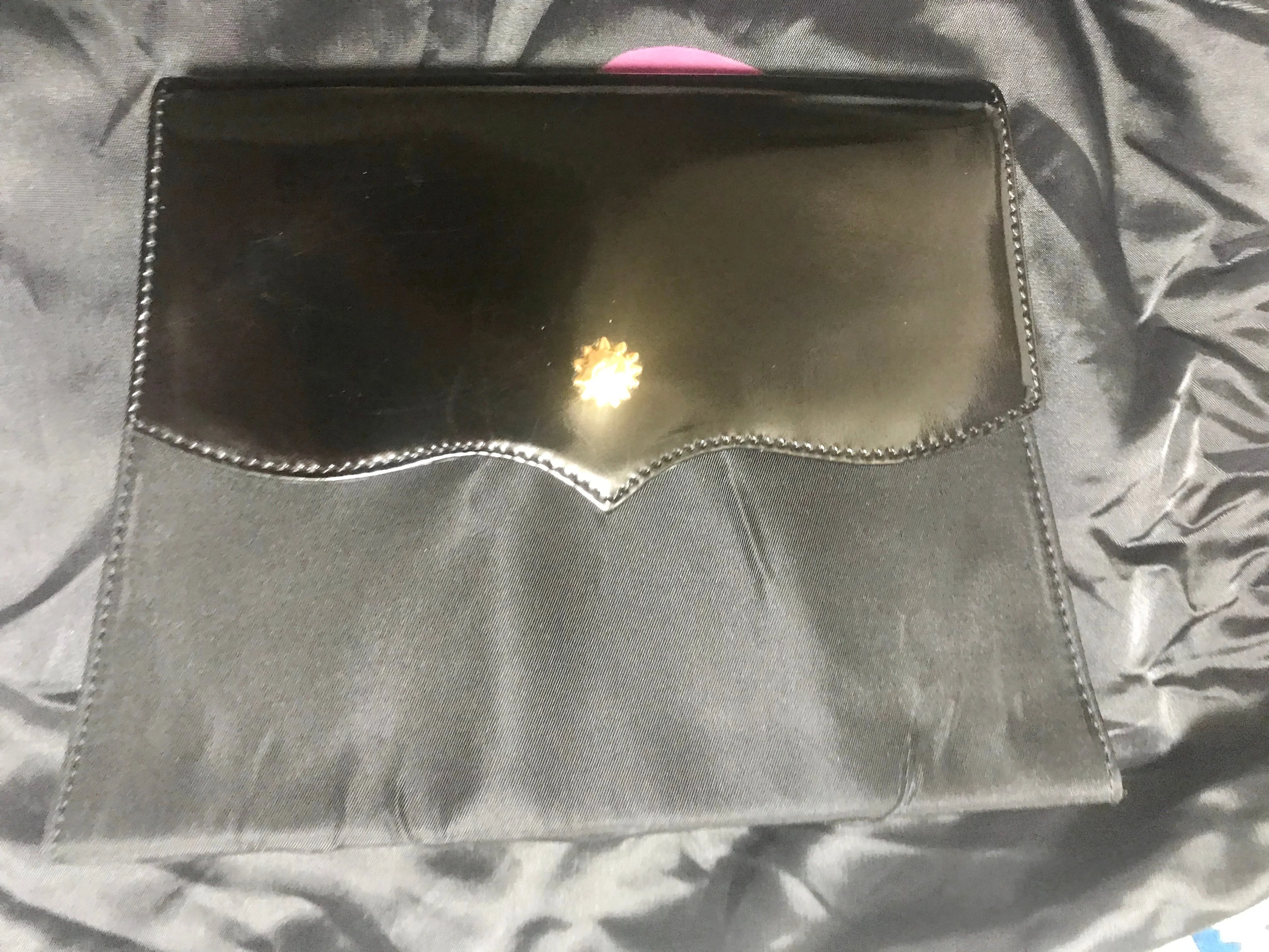Vintage Christian Lacroix black patent enamel and nylon combo clutch bag with a sun flower shape logo motif.